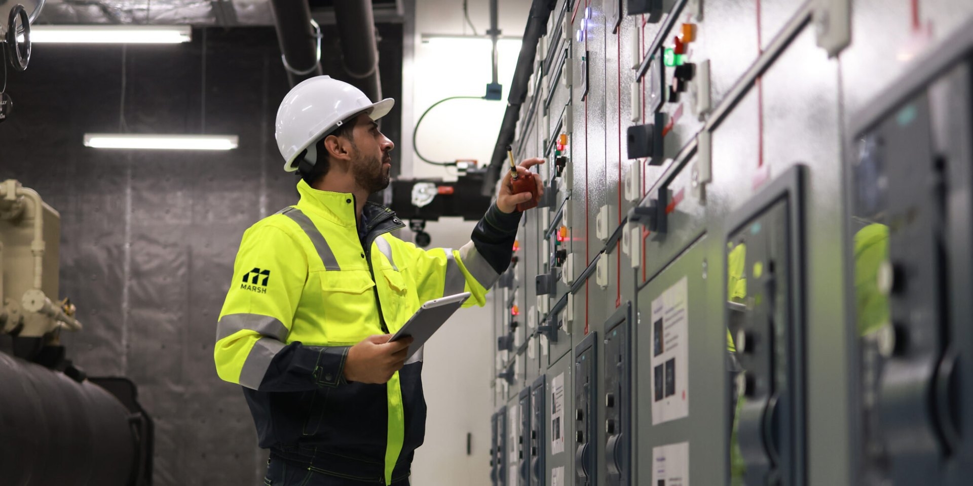 Engineer in hi-vis checking switchgear panels